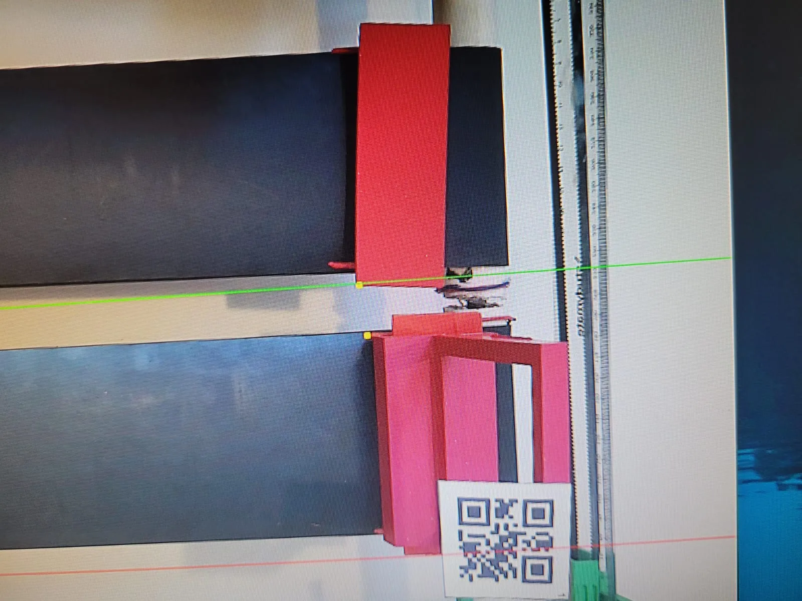 A zoomed in view of the same scene with the red tray and holder outlined, yellow target points marked, and a green horizontal line drawn across the image.